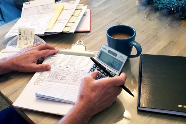 morning-routines-in-retirement-life-involve-drinking-coffee-while-paying-monthly-bills-using-hands_t20_9lXdZ6